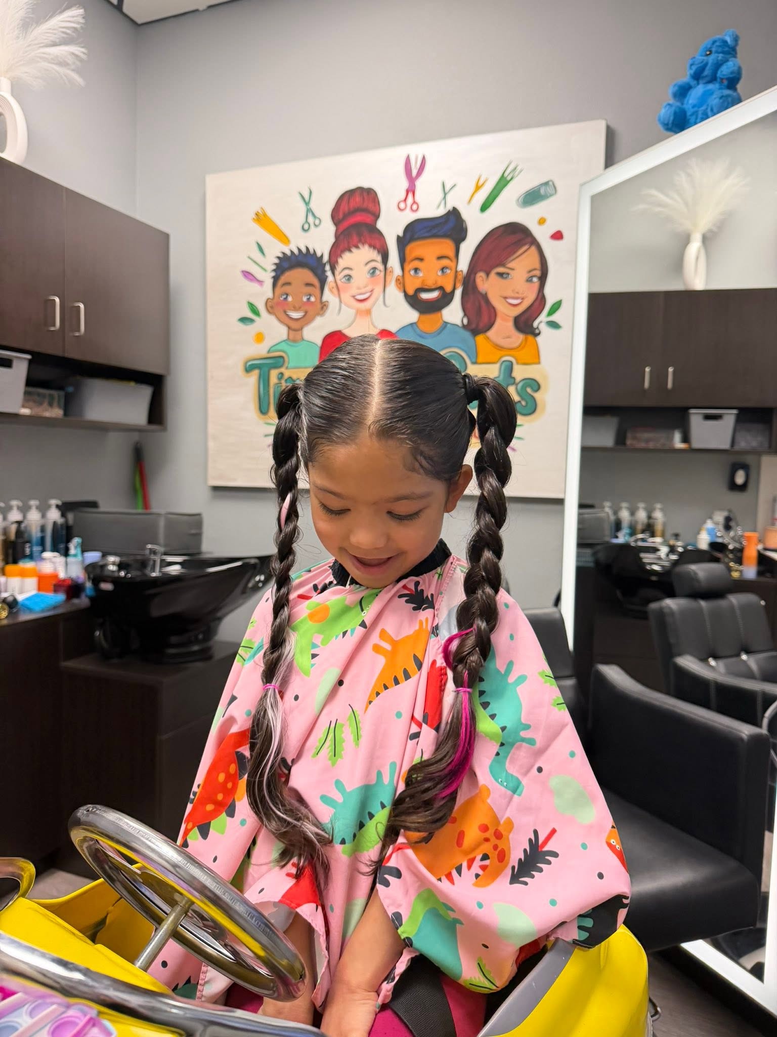 Happy child during first haircut at Timeless Cuts